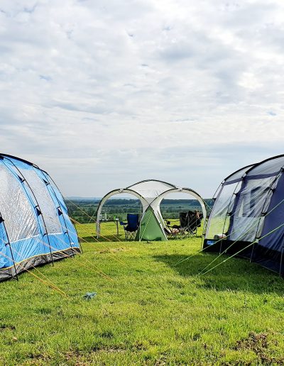 Family tents on Nuns Hill with a view over the Vale